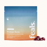 A product image of Feals Bedtime Berry Sleep Gummies with four sleep gummies positioned in front of it.